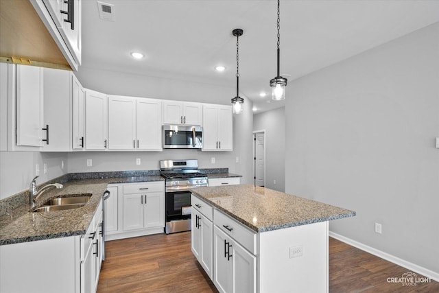 kitchen featuring sink, a kitchen island, white cabinets, and appliances with stainless steel finishes