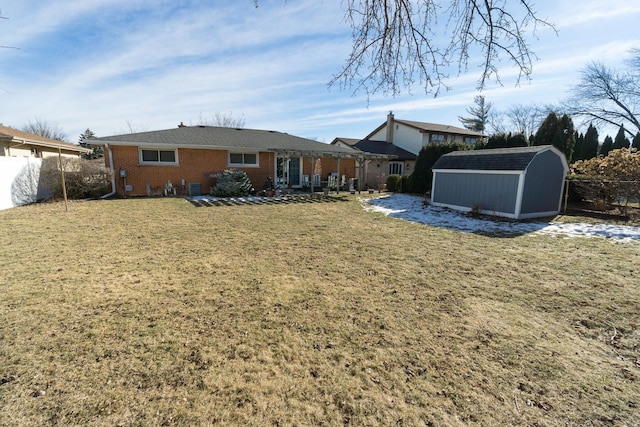 exterior space featuring a lawn and a storage unit