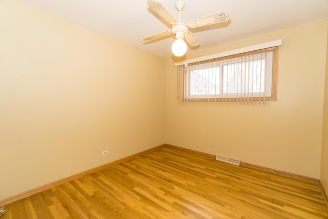 empty room with ceiling fan and light hardwood / wood-style floors