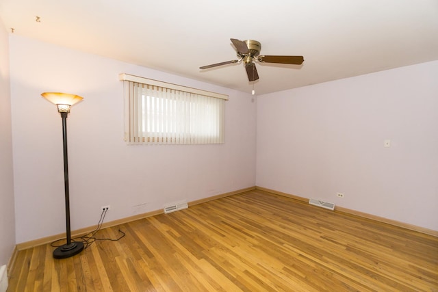 empty room with light hardwood / wood-style floors and ceiling fan