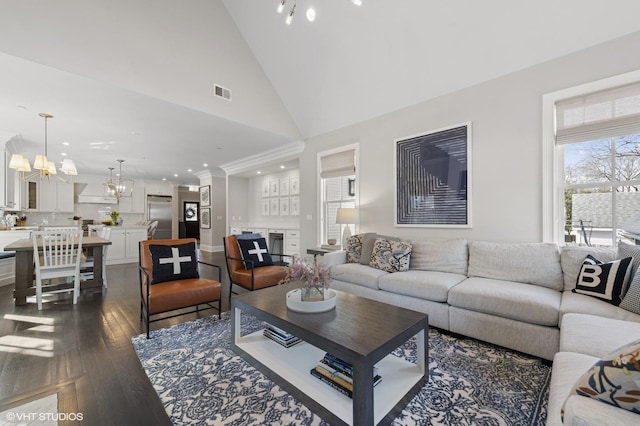 living room with recessed lighting, dark wood-style flooring, high vaulted ceiling, visible vents, and a notable chandelier