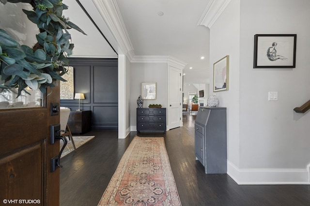 entrance foyer with dark wood-style flooring, crown molding, and baseboards