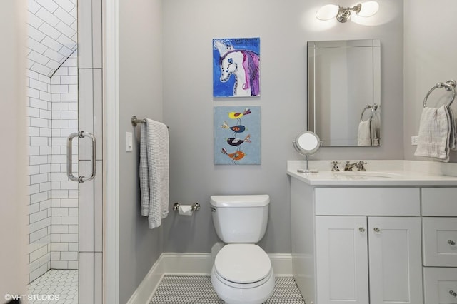 full bath featuring vanity, toilet, baseboards, tile patterned floors, and a stall shower