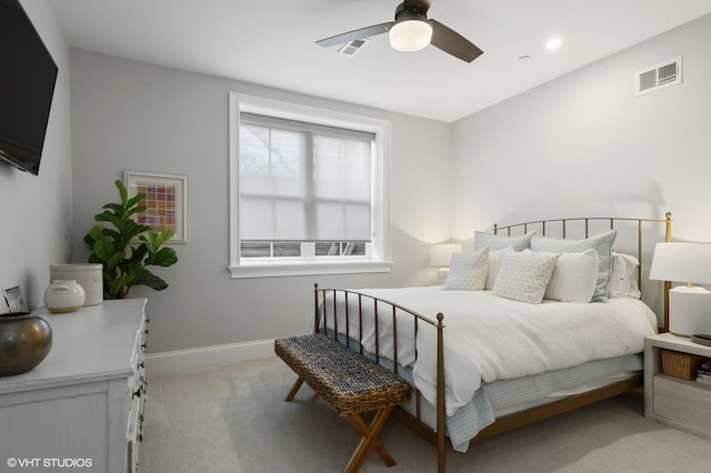 bedroom with baseboards, ceiling fan, visible vents, and light colored carpet