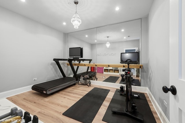workout room featuring baseboards, wood finished floors, and recessed lighting