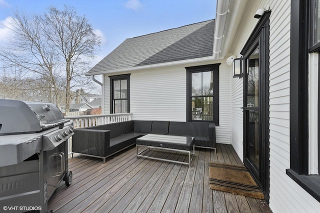 wooden deck featuring outdoor lounge area and a grill