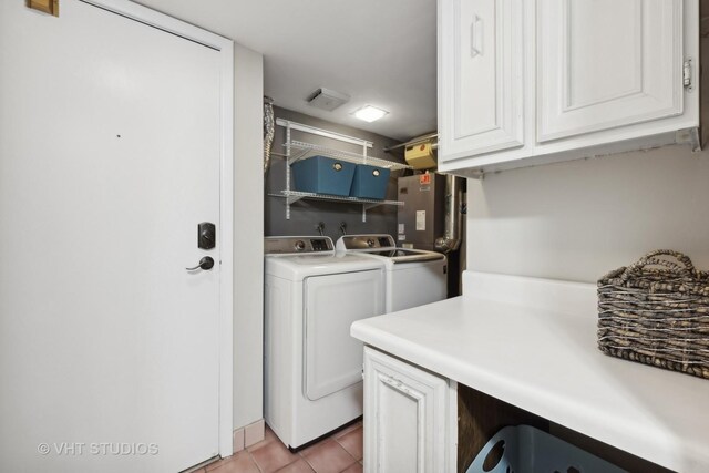 laundry room featuring washing machine and dryer and light tile patterned floors