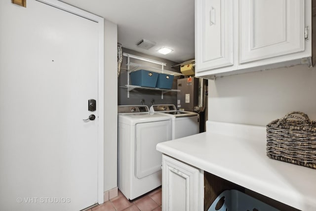 clothes washing area featuring light tile patterned floors and washing machine and clothes dryer