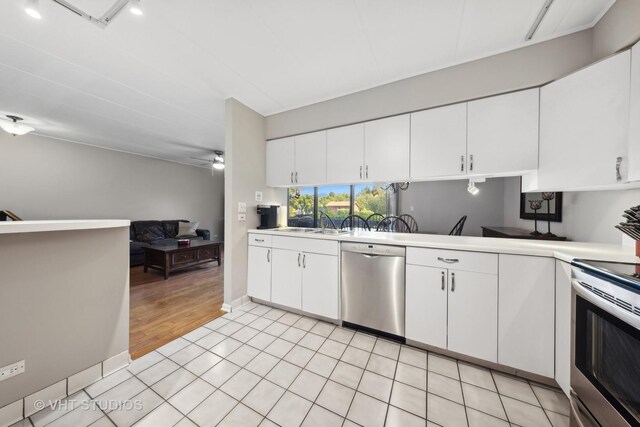 kitchen with sink, stainless steel appliances, and white cabinets