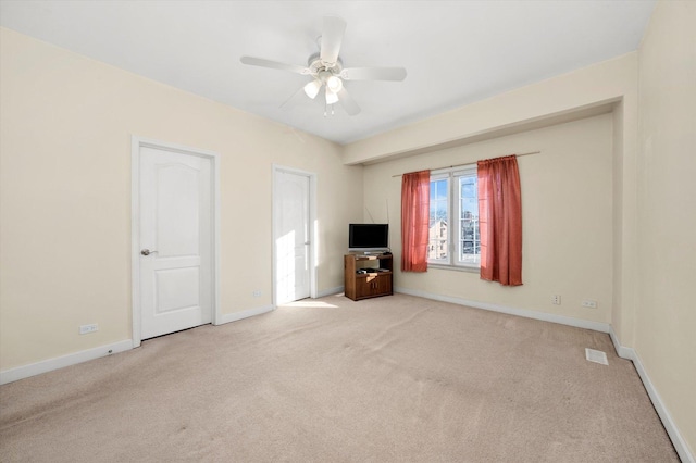 unfurnished bedroom with light colored carpet and ceiling fan