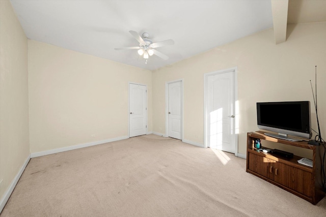 carpeted living room with vaulted ceiling with beams and ceiling fan