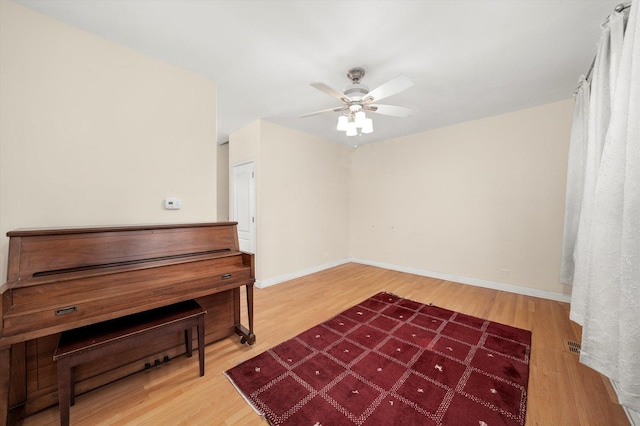 miscellaneous room with hardwood / wood-style flooring and ceiling fan