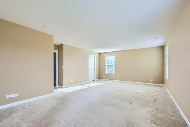 unfurnished room featuring light colored carpet