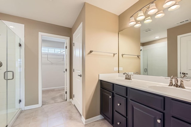 bathroom with vanity, tile patterned floors, and walk in shower