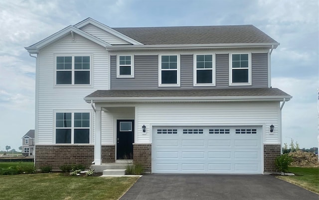 view of front of house with a garage and a front lawn