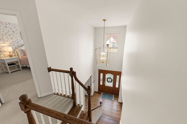 entrance foyer with a chandelier, baseboards, and wood finished floors