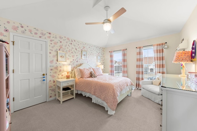 bedroom with wallpapered walls, vaulted ceiling, and light colored carpet