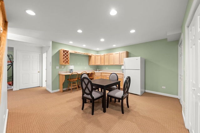 dining area featuring baseboards, light colored carpet, and recessed lighting