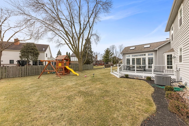 view of yard with a fenced backyard, central AC unit, a playground, and a wooden deck