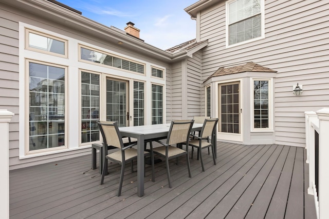 wooden terrace with outdoor dining space