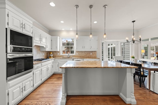 kitchen with white cabinetry, a kitchen island, and appliances with stainless steel finishes