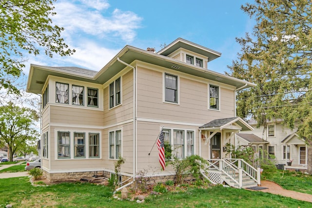 back of house with a lawn and central AC unit