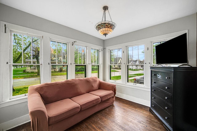 sunroom / solarium with baseboards, french doors, and wood finished floors