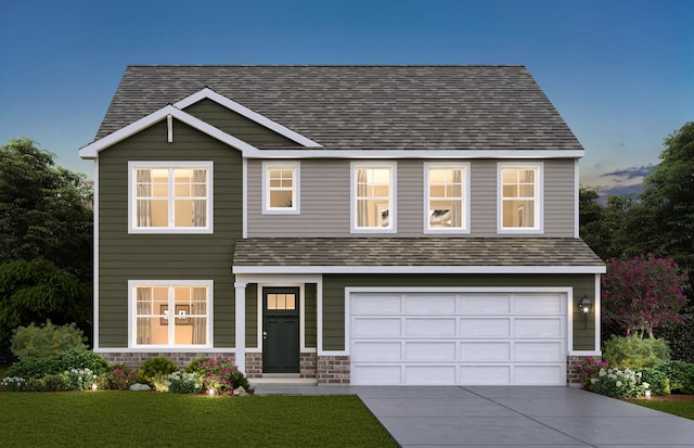 view of front of home with a garage and a yard