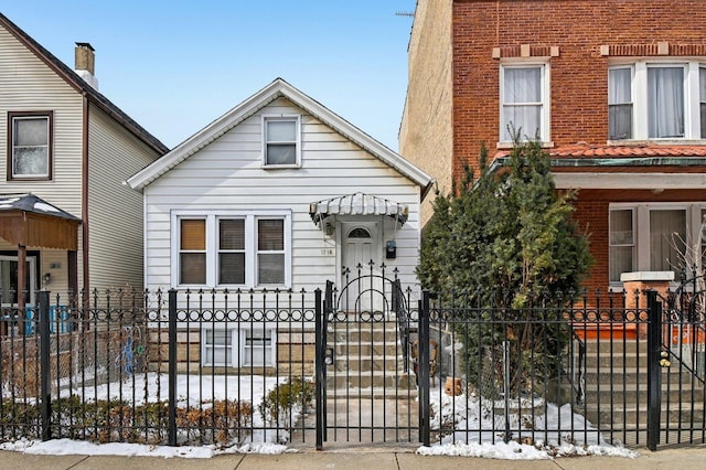 view of front of property with a fenced front yard and a gate