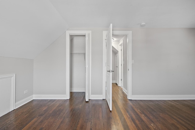 additional living space featuring dark hardwood / wood-style floors and vaulted ceiling