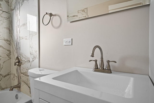 full bathroom featuring vanity, toilet, and tiled shower / bath combo