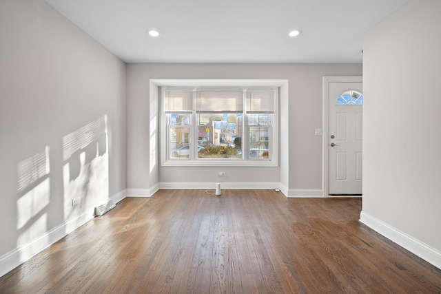 unfurnished living room with dark hardwood / wood-style flooring