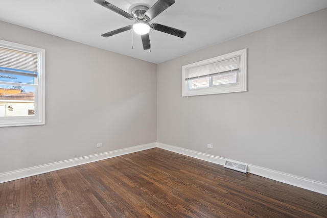 empty room with ceiling fan and dark hardwood / wood-style floors