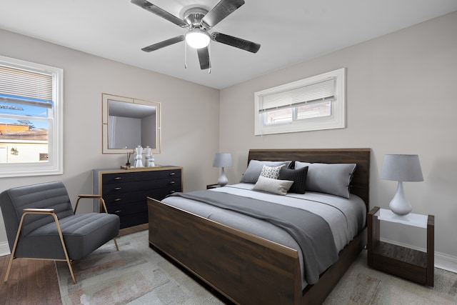 bedroom featuring light colored carpet and ceiling fan