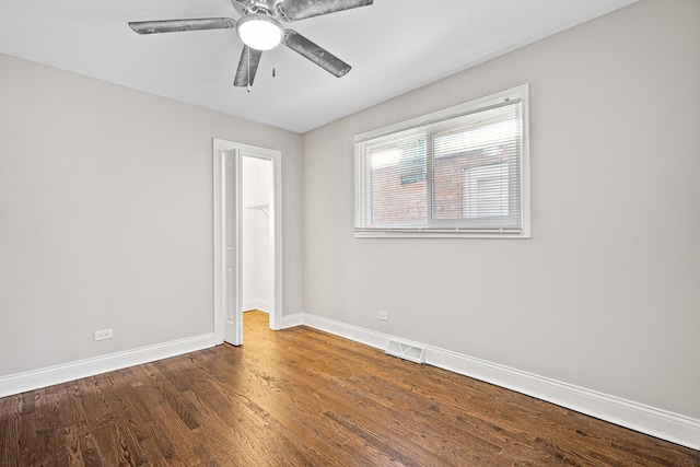 empty room featuring dark hardwood / wood-style floors and ceiling fan