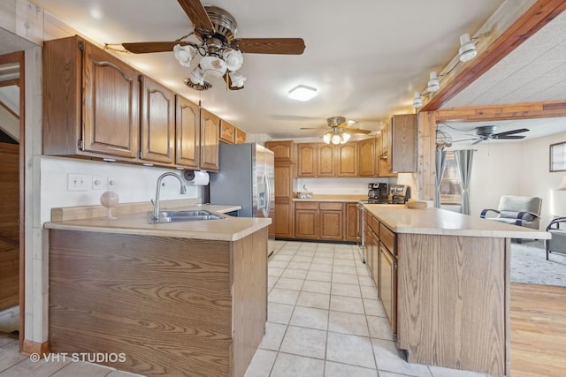 kitchen with sink, light tile patterned floors, and ceiling fan