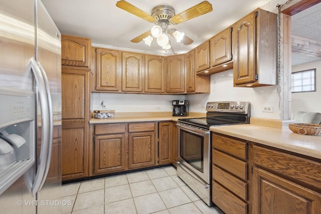 kitchen with light tile patterned floors, ceiling fan, and appliances with stainless steel finishes