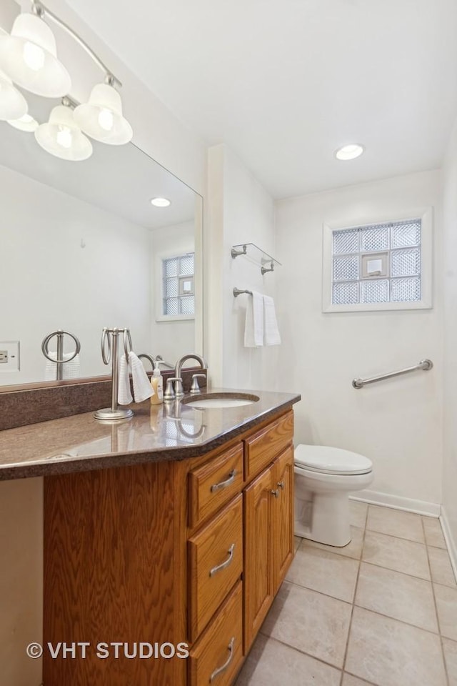 bathroom with vanity, tile patterned floors, and toilet