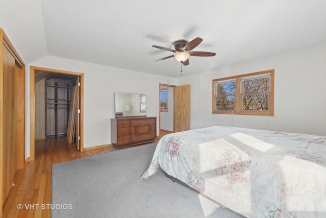 bedroom with hardwood / wood-style flooring, ceiling fan, and a closet