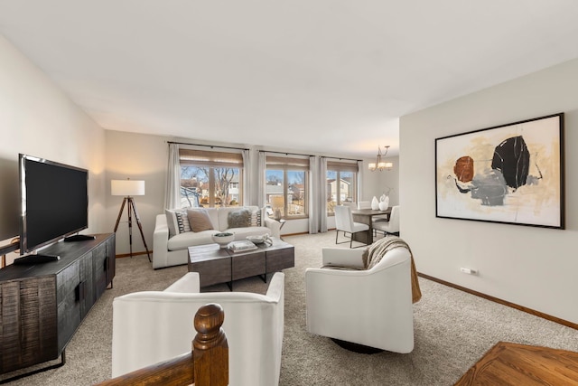 carpeted living room featuring a notable chandelier