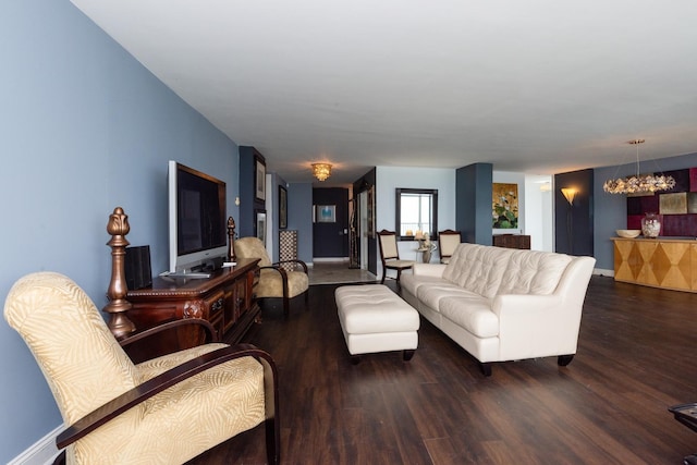 living room featuring dark hardwood / wood-style flooring and an inviting chandelier