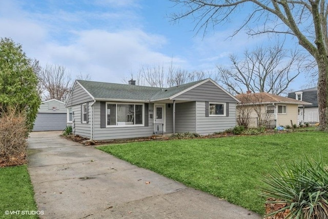 ranch-style home with a garage, an outdoor structure, and a front lawn