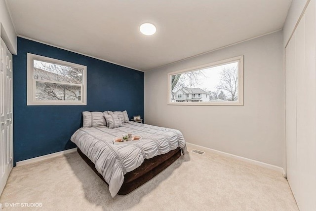 carpeted bedroom with a closet