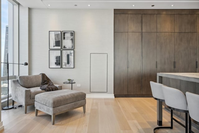 interior space featuring floor to ceiling windows and light hardwood / wood-style floors