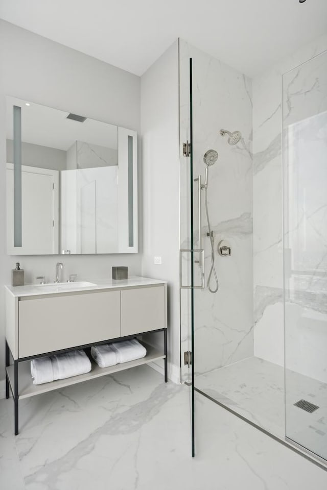 bathroom featuring vanity and a shower with door