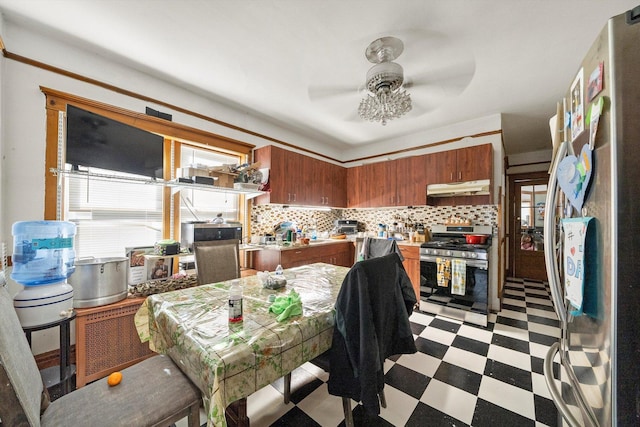 kitchen featuring ceiling fan, stainless steel appliances, and backsplash