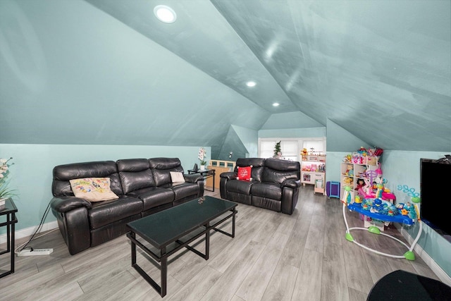 living room with vaulted ceiling and light hardwood / wood-style floors