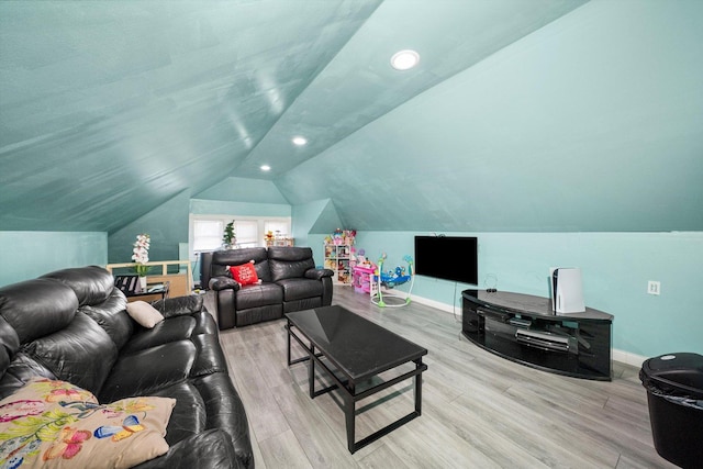 living room with vaulted ceiling and light wood-type flooring