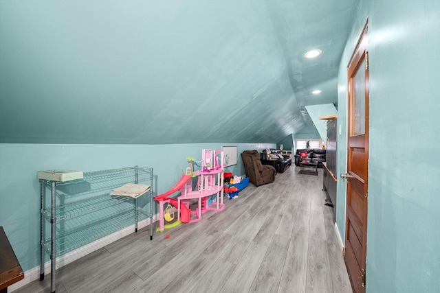 playroom featuring vaulted ceiling and light hardwood / wood-style floors