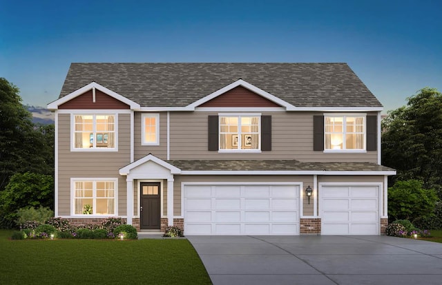 view of front of home with a garage and a front lawn